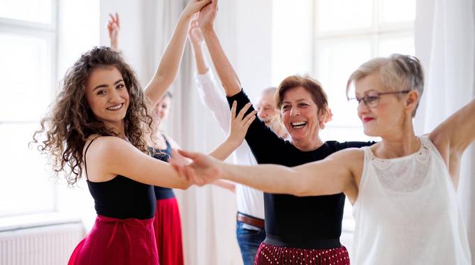adobestock 291519681 halfpoint group of senior people in dancing class with dance teacher