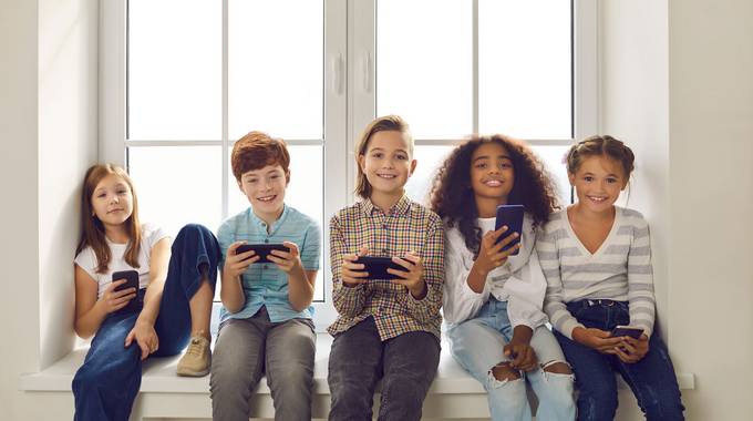 Eine Gruppe von Kindern mit smartphone © Studio Romantic – stock.adobe.com Eine Gruppe von Kindern mit smartphone
