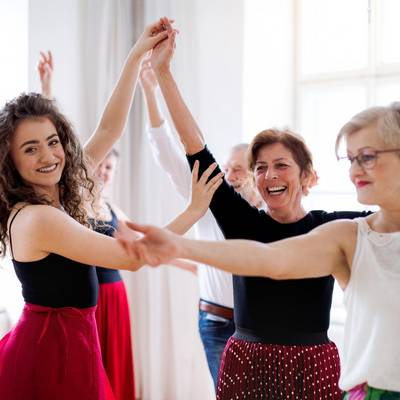 adobestock 291519681 halfpoint group of senior people in dancing class with dance teacher