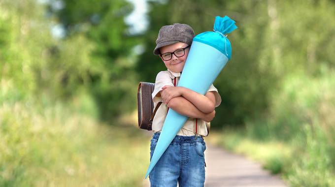 Ein Junge mit einer blauen Schultüte